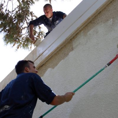 060904-N-3594V-001 Limassol, Cyprus (Sept. 4, 20060 - Interior Communications Electrician 3rd Class Steve Chisholm (bottom) and Electronics Technician 3rd Class Joshua Miller paint the exterior walls of the Theotokos Foundation in Limassol, Cyprus, as part of a community relations project. About 50 service members and civilian mariners from USS Mount Whitney (LCC/JCC 20) and the embarked Joint Task Force (JTF) Lebanon staff participated in the painting of the residence. JTF Lebanon is responsible for the U.S. military aspects of the joint interagency efforts of the Department of State and the Department of Defense, which have resulted in the assisted departure of almost 15,000 American citizens from Lebanon and the distribution of millions of dollars in aid to the Lebanese people. U.S. Navy photo by Gunner's Mate 2nd Class Elizabeth Vlahos (RELEASED)